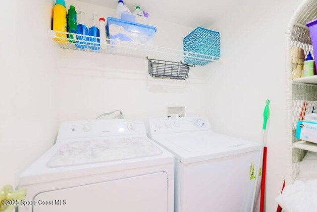 laundry area with washer and clothes dryer and laundry area