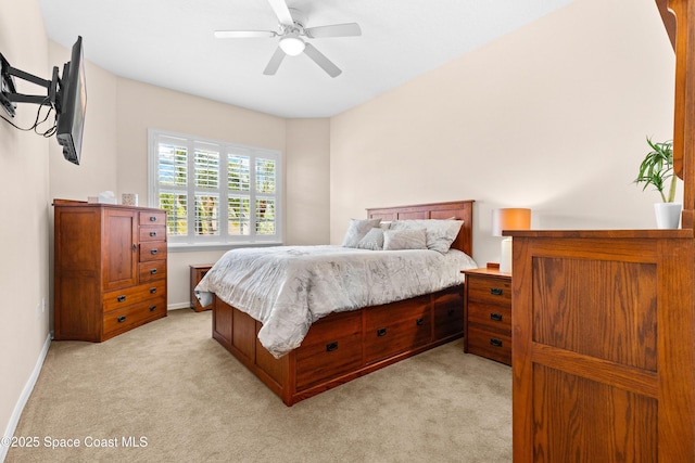 bedroom featuring baseboards, a ceiling fan, and light colored carpet