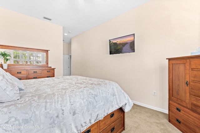 bedroom featuring visible vents, light colored carpet, and baseboards