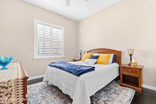 bedroom featuring a ceiling fan, wood finished floors, and baseboards