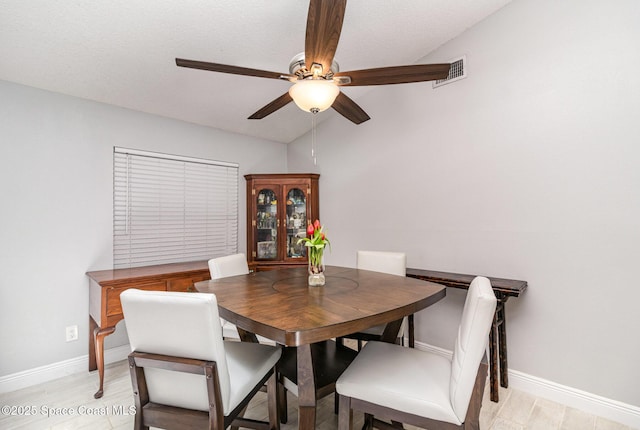 dining area with light wood-type flooring, baseboards, a ceiling fan, and visible vents