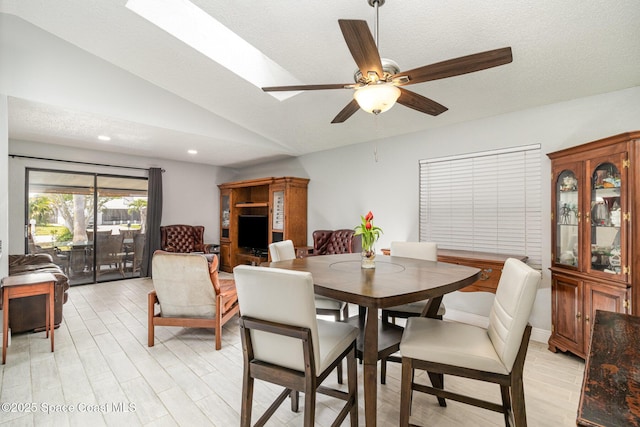 dining space with light wood finished floors, lofted ceiling, recessed lighting, and ceiling fan