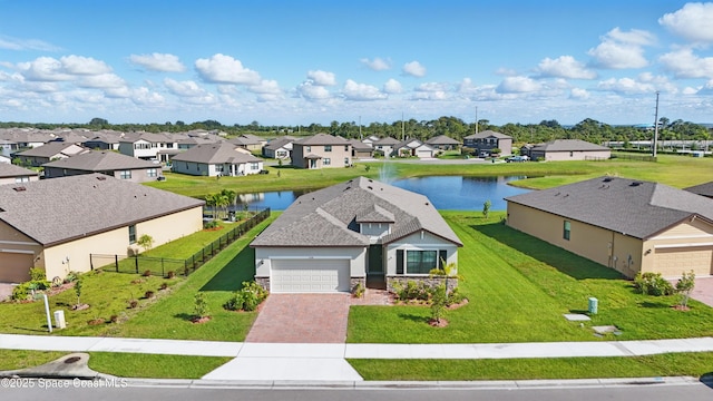 5358 Waterfall Pl, Grant, FL 32949 - view of front of property featuring a residential view, driveway, a water view, a garage, and stone siding