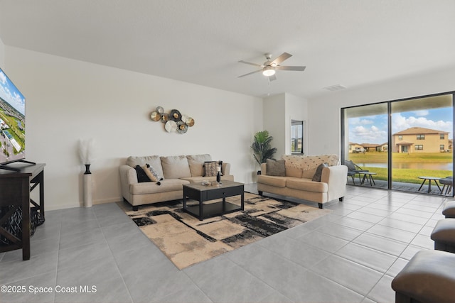 5358 Waterfall Pl, Grant, FL 32949 - living room featuring a ceiling fan, plenty of natural light, tile patterned flooring, and a water view
