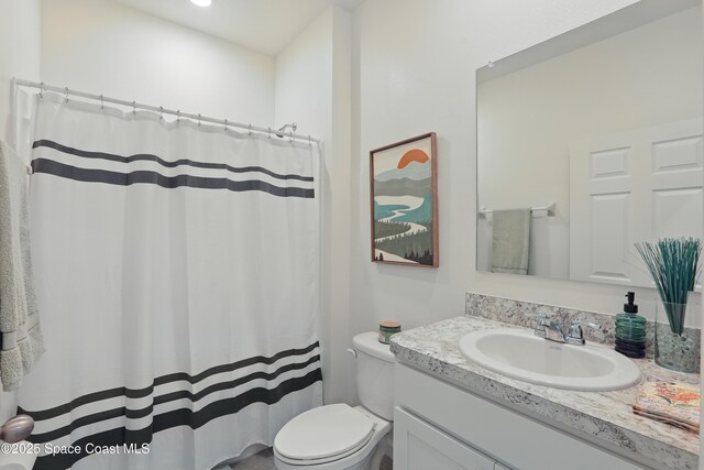 5358 Waterfall Pl, Grant, FL 32949 - full bathroom with vanity, toilet, and a shower with shower curtain
