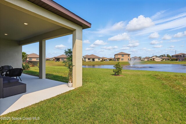 5358 Waterfall Pl, Grant, FL 32949 - view of grassy yard featuring a water view, a residential view, and a patio area