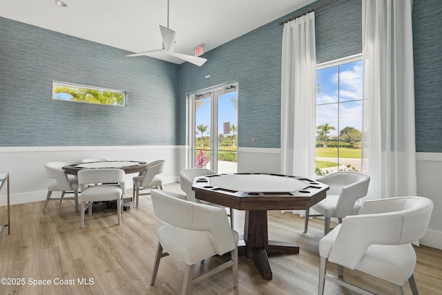 5358 Waterfall Pl, Grant, FL 32949 - dining room with plenty of natural light, wainscoting, light wood finished floors, and wallpapered walls