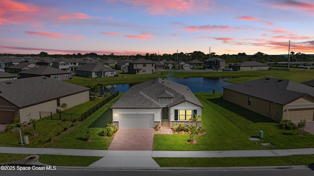 5358 Waterfall Pl, Grant, FL 32949 - view of front of house featuring driveway, a water view, a garage, a residential view, and stone siding