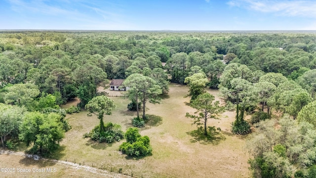 drone / aerial view featuring a forest view