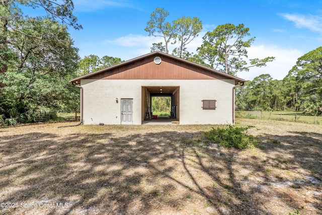 view of outdoor structure with an outbuilding and fence