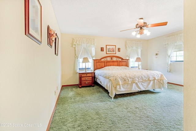 carpeted bedroom featuring baseboards and ceiling fan