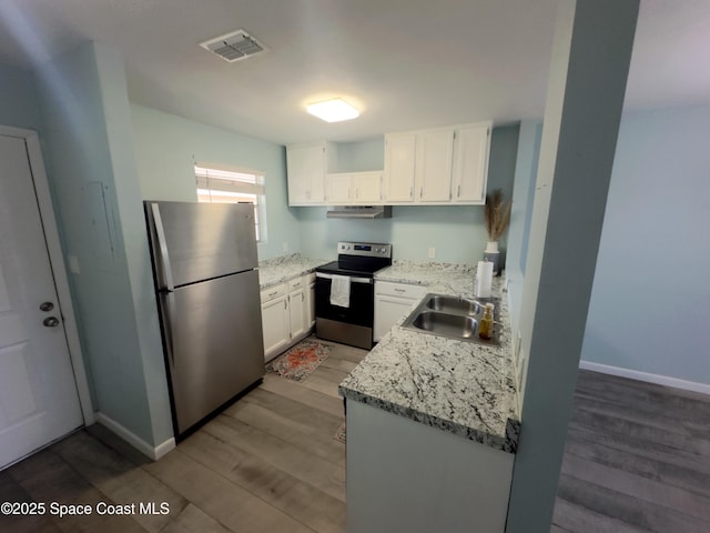 kitchen featuring wood finished floors, a sink, white cabinets, appliances with stainless steel finishes, and visible vents