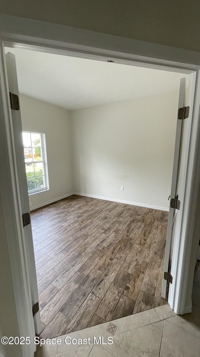 466 Stonehenge Cir, Rockledge, FL 32955 - spare room with baseboards and wood finished floors