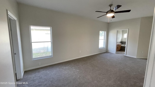 466 Stonehenge Cir, Rockledge, FL 32955 - unfurnished bedroom with baseboards, ensuite bathroom, and dark carpet