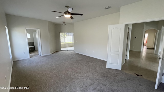 466 Stonehenge Cir, Rockledge, FL 32955 - unfurnished bedroom featuring connected bathroom, carpet floors, arched walkways, baseboards, and visible vents