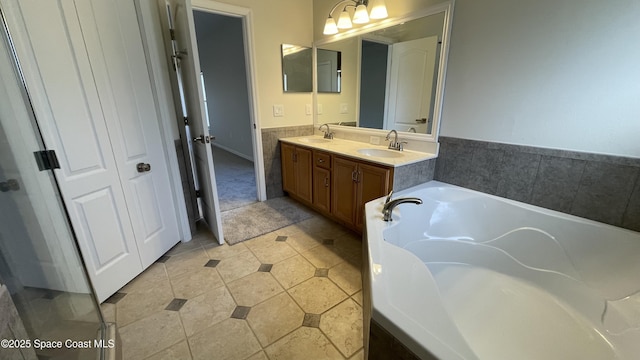 466 Stonehenge Cir, Rockledge, FL 32955 - full bathroom featuring a sink, tile patterned floors, a garden tub, and double vanity