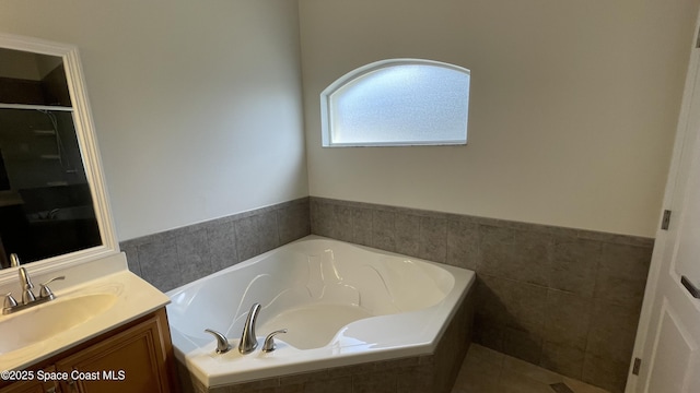 466 Stonehenge Cir, Rockledge, FL 32955 - full bathroom with wainscoting, vanity, walk in shower, and a garden tub
