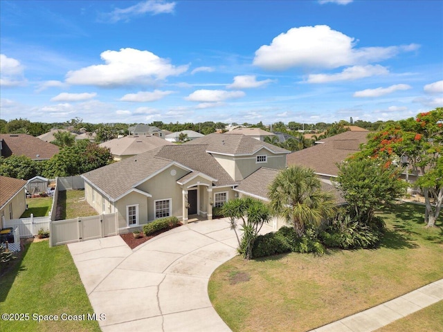 466 Stonehenge Cir, Rockledge, FL 32955 - mediterranean / spanish-style house with a gate, curved driveway, roof with shingles, and a residential view