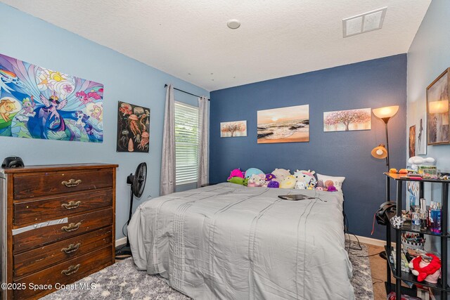 bedroom featuring baseboards, carpet flooring, and visible vents
