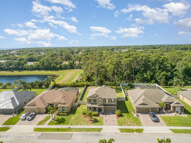 aerial view featuring a water view, a residential view, and a forest view