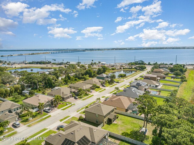 bird's eye view featuring a water view and a residential view