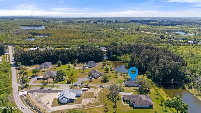 aerial view featuring a water view and a wooded view