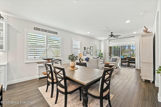dining room featuring a ceiling fan, a healthy amount of sunlight, dark wood-type flooring, and recessed lighting