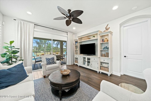living area featuring dark wood finished floors, ceiling fan, and recessed lighting