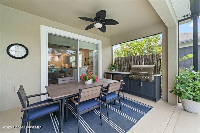 view of patio with a grill, fence, a ceiling fan, and outdoor dining space