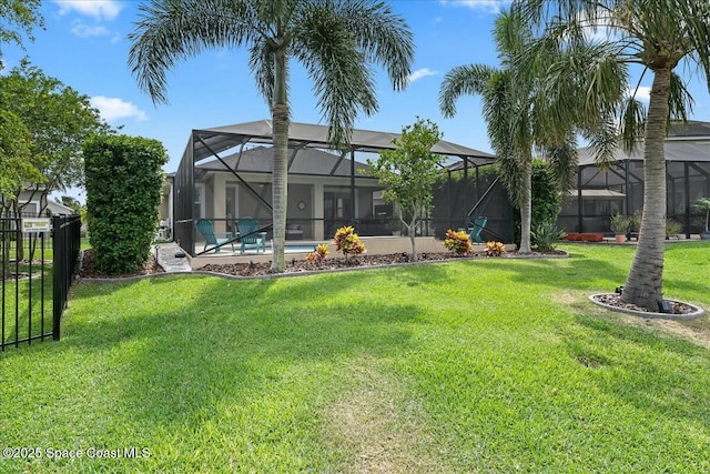 rear view of house with a yard and fence