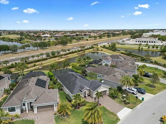drone / aerial view with a residential view and a water view