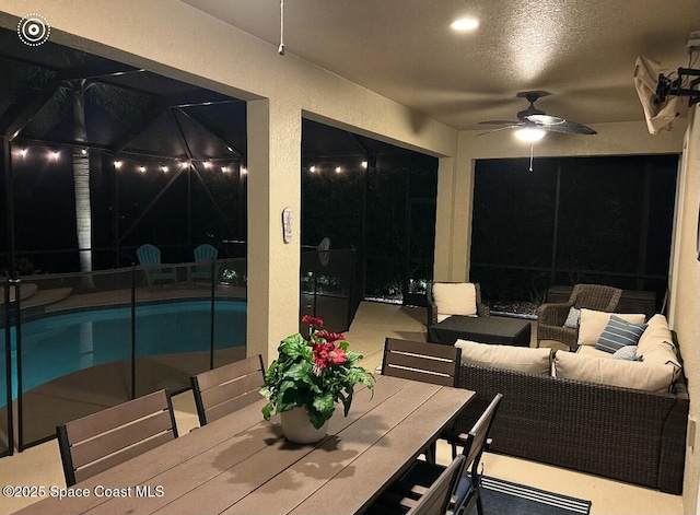 interior space featuring an outdoor hangout area, a ceiling fan, and an outdoor pool