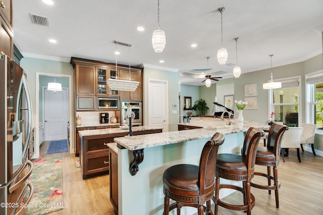 kitchen featuring ceiling fan with notable chandelier, visible vents, a large island, appliances with stainless steel finishes, and recessed lighting