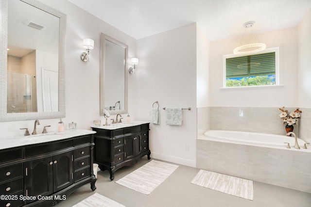 full bathroom featuring a stall shower, a sink, a bath, visible vents, and tile patterned flooring
