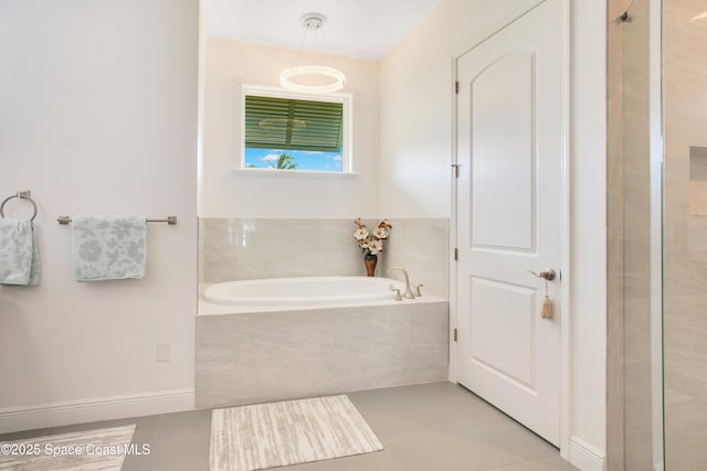 full bathroom featuring tile patterned flooring and a bath