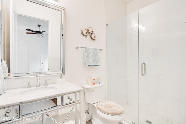 full bath featuring a ceiling fan, vanity, toilet, and a shower stall