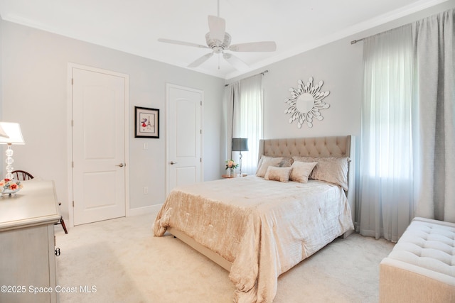 bedroom featuring light colored carpet, baseboards, and ceiling fan