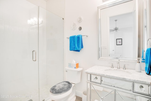 full bath with a shower stall, vanity, toilet, and a ceiling fan
