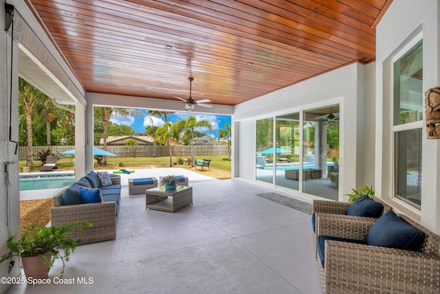 view of patio with outdoor lounge area, a fenced in pool, ceiling fan, and a fenced backyard