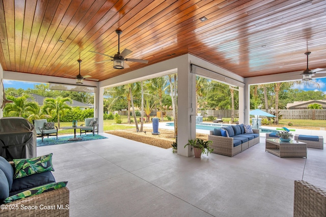 view of patio / terrace with an outdoor living space, a fenced backyard, grilling area, a fenced in pool, and a ceiling fan