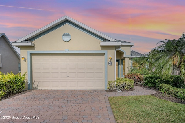 6921 Abbeyville Rd, Melbourne, FL 32940 - single story home with decorative driveway, stucco siding, and a garage
