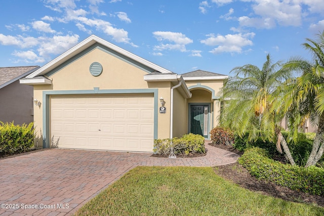 6921 Abbeyville Rd, Melbourne, FL 32940 - view of front of home with an attached garage, decorative driveway, and stucco siding