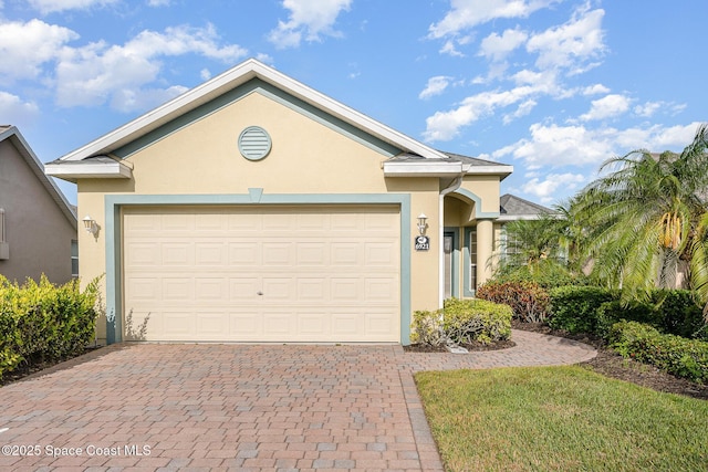 6921 Abbeyville Rd, Melbourne, FL 32940 - single story home with an attached garage, decorative driveway, and stucco siding