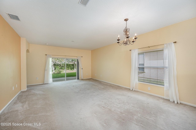 6921 Abbeyville Rd, Melbourne, FL 32940 - spare room featuring carpet flooring, an inviting chandelier, and visible vents