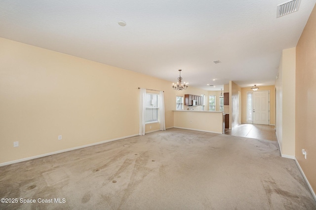 6921 Abbeyville Rd, Melbourne, FL 32940 - unfurnished living room with a notable chandelier, baseboards, light carpet, and visible vents