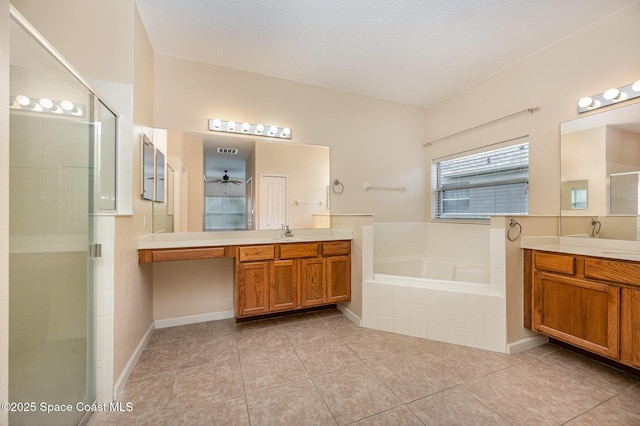 6921 Abbeyville Rd, Melbourne, FL 32940 - bathroom with a bath, two vanities, a sink, and a shower stall