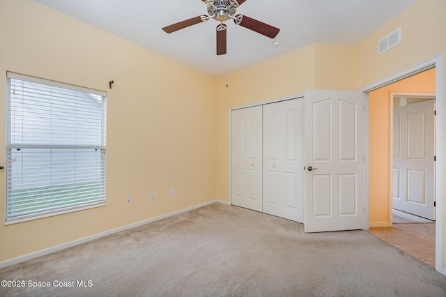 6921 Abbeyville Rd, Melbourne, FL 32940 - unfurnished bedroom featuring a closet, carpet, baseboards, visible vents, and a ceiling fan