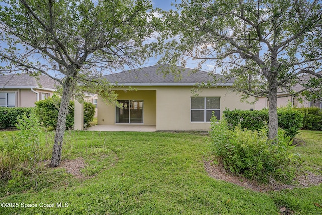 6921 Abbeyville Rd, Melbourne, FL 32940 - back of house with a lawn, stucco siding, and a patio area