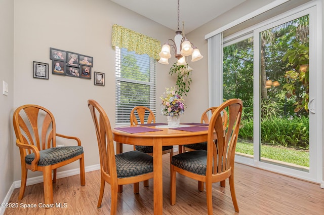 3321 San Jacinto Cir, Sanford, FL 32771 - dining space with an inviting chandelier, baseboards, light wood-style flooring, and a healthy amount of sunlight