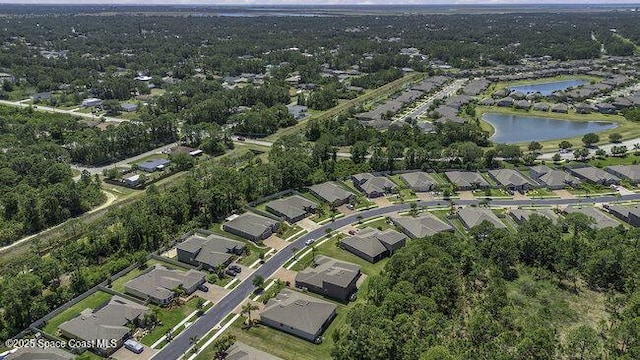 birds eye view of property with a water view and a residential view